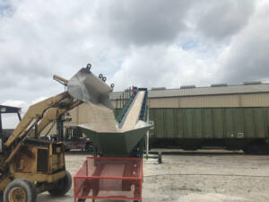 Oyster shells being transloaded into hopper car