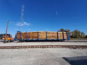 Pole transload onto flatcar